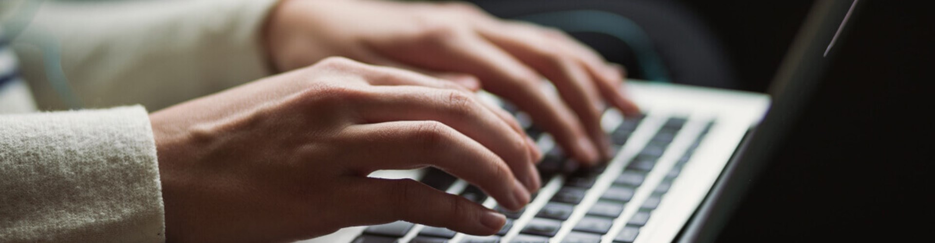 Student typing on a keyboard