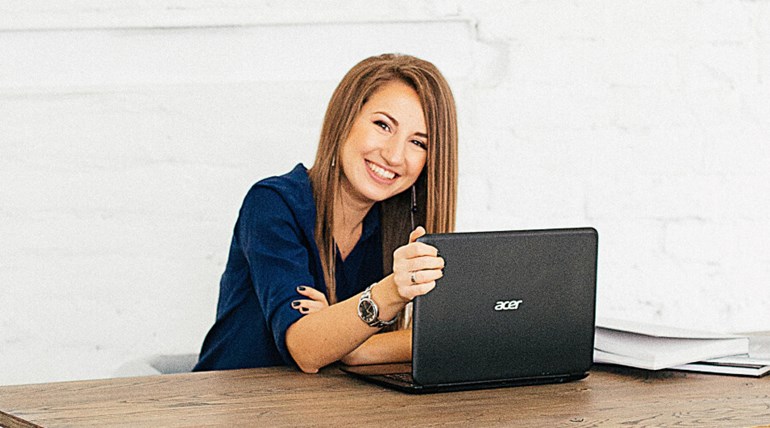 Woman on laptop smiling