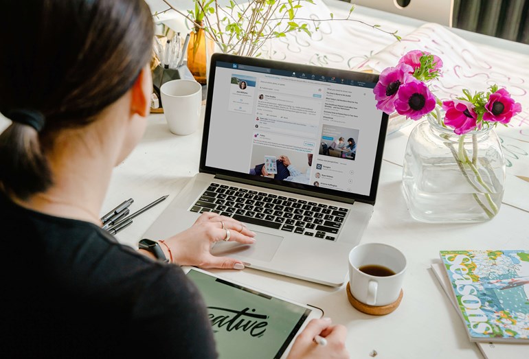 Woman updating Linkedin Profile on laptop