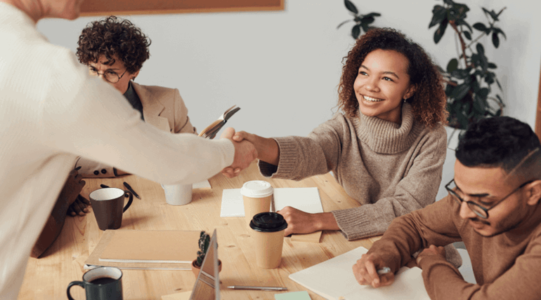 Student Shaking Hand in a Group Meeting