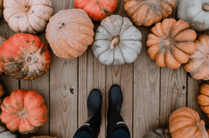 Boots surrounded by pumpkins