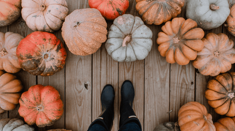 Boots surrounded by pumpkins