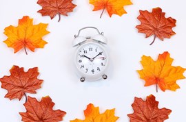 Clock surrounded by maple leaves