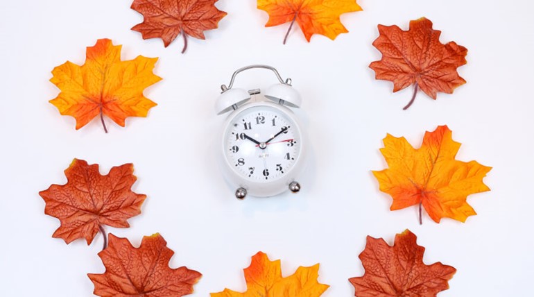 Clock surrounded by maple leaves