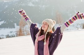 Woman enjoying the snow outdoors