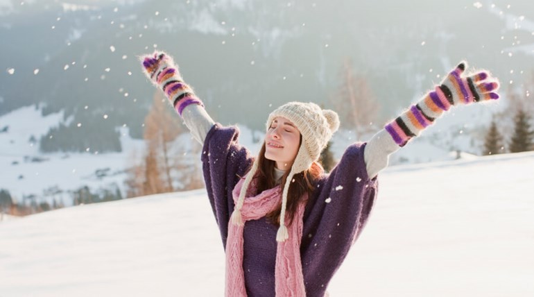 Woman enjoying the snow outdoors