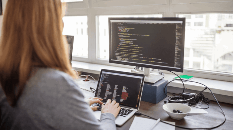 Woman coding on a laptop