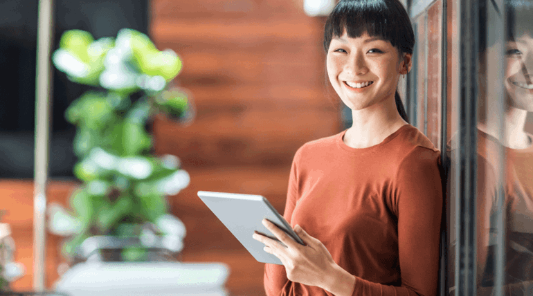 Student smiling with Tablet in hand