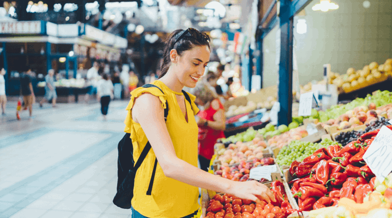 A woman picking fruits to buy