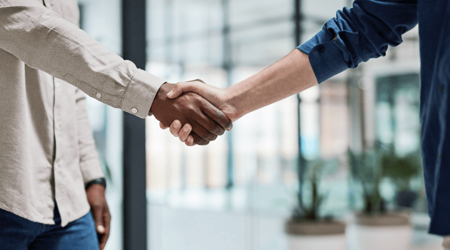 Two men shaking hands in an office