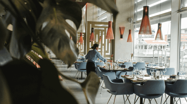 Waitress organizing the tables at a restaurant