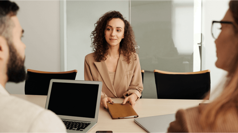 Woman in brown long sleeve shirt having an interview 