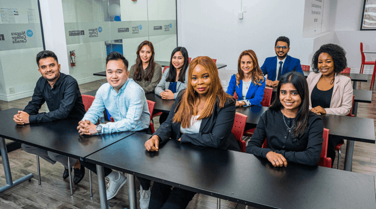 Students facing the camera and smiling