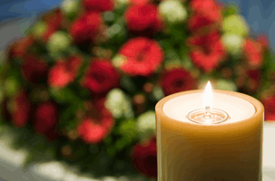Candle with flowers in the background