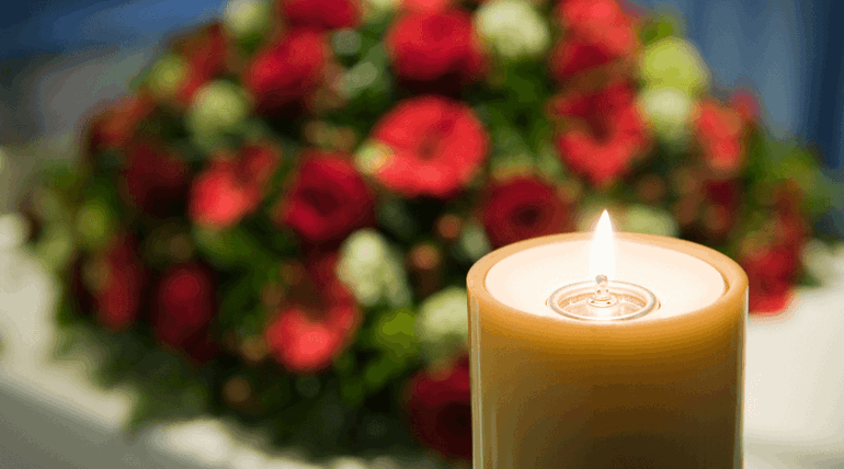 Candle with flowers in the background