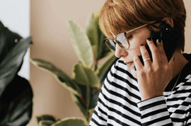 Woman with glasses talking on phone