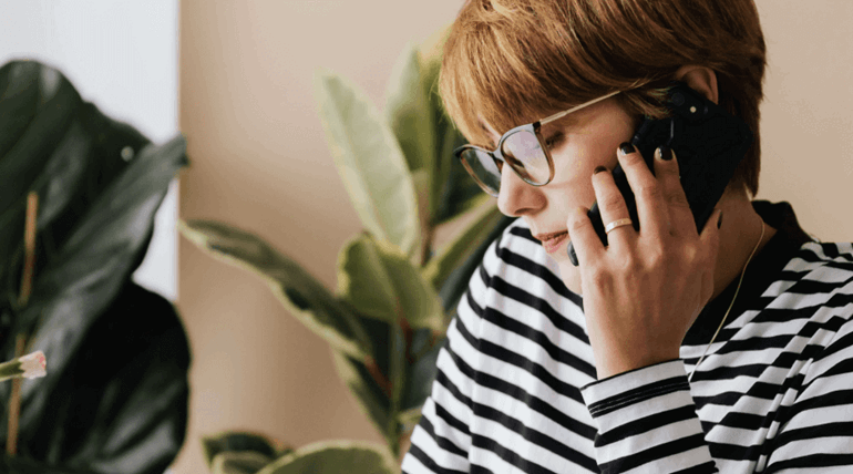 Woman with glasses talking on phone