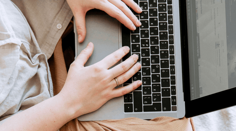 Woman updating Linkedin Profile on laptop