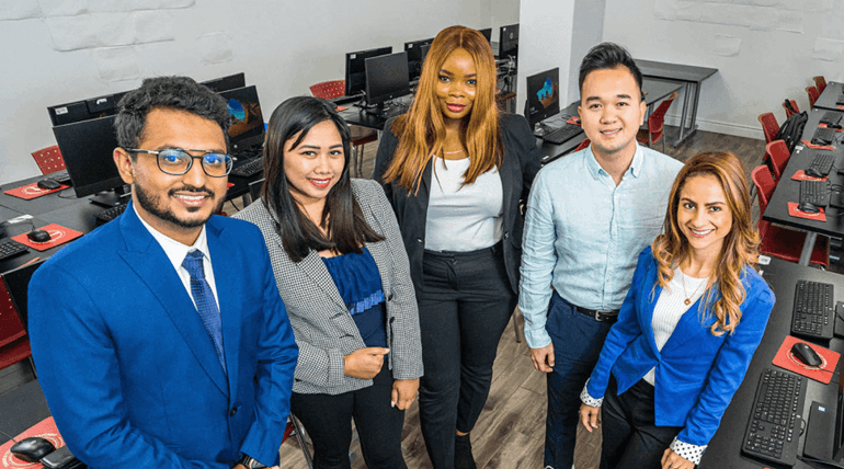 Students facing the camera and smiling