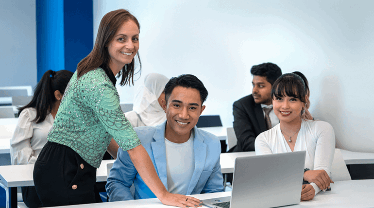 Students facing the camera and smiling