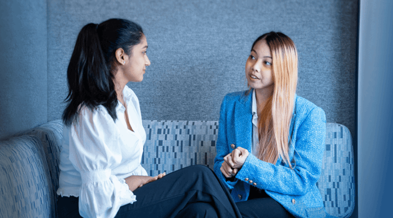 Young lady giving an interview advice to a college student